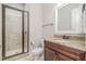 Well-lit bathroom featuring a glass shower and granite vanity with wood cabinets at 304 Villa Dr, Durham, NC 27712