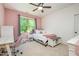Pink bedroom with a cozy bed and a large window, complemented by a modern desk area at 304 Villa Dr, Durham, NC 27712