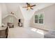 Spacious bonus room offering natural light and ceiling fans with neutral carpeting at 304 Villa Dr, Durham, NC 27712