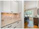 Convenient butler's pantry area with granite countertop and views into the dining room at 304 Villa Dr, Durham, NC 27712