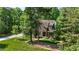 Charming home featuring an earthy, split stone and siding exterior with lush, well-manicured landscaping at 304 Villa Dr, Durham, NC 27712