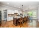 Bright kitchen features a large island with seating and white cabinetry, offering ample counter space and storage at 304 Villa Dr, Durham, NC 27712