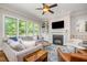 Bright and open living room featuring a cozy fireplace and built-in shelving at 304 Villa Dr, Durham, NC 27712