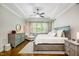 Spacious main bedroom with tray ceiling, hardwood floors, and a sitting area, flooded with natural light at 304 Villa Dr, Durham, NC 27712