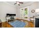 Bright office space with hardwood floors, a desk area, and French doors to a screened porch at 304 Villa Dr, Durham, NC 27712