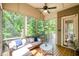 Comfortable seating on the screened-in porch with views of the surrounding nature at 304 Villa Dr, Durham, NC 27712
