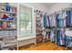 Well-organized walk-in closet with custom shelving, hanging rods, and a window for natural light at 304 Villa Dr, Durham, NC 27712
