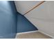 Small attic space featuring blue wall, slanted ceiling, and laminate flooring at 3312 Hawk Ridge Rd, Chapel Hill, NC 27516