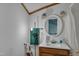 Cozy bathroom features a white vanity, round mirror, and classic fixtures for a charming, functional space at 3312 Hawk Ridge Rd, Chapel Hill, NC 27516