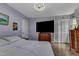 Large bedroom featuring a king-size bed, a wall mounted TV, and great closet space at 3312 Hawk Ridge Rd, Chapel Hill, NC 27516