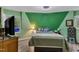 Cozy bedroom featuring vibrant, two-tone paint scheme, a comfortable queen-size bed and views of nature at 3312 Hawk Ridge Rd, Chapel Hill, NC 27516