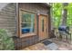 Entry to a dome home with door and gas grill, showcasing unique architectural design at 3312 Hawk Ridge Rd, Chapel Hill, NC 27516