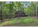 Geodesic dome house exterior amidst trees, showing brown siding and covered porch at 3312 Hawk Ridge Rd, Chapel Hill, NC 27516