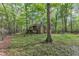 Unique dome-shaped home with a stone chimney and wooded surroundings, blending modern design with nature at 3312 Hawk Ridge Rd, Chapel Hill, NC 27516