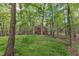 Geodesic dome house with stone chimney, stairs, and forest surroundings at 3312 Hawk Ridge Rd, Chapel Hill, NC 27516