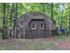 Unique geodesic dome home featuring a shingled roof nestled within a wooded landscape at 3312 Hawk Ridge Rd, Chapel Hill, NC 27516