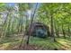 Geodesic dome house with shingled roof and small porch in a dense forest environment at 3312 Hawk Ridge Rd, Chapel Hill, NC 27516