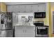 Well-lit kitchen featuring stainless steel appliances, white cabinets, and a double basin sink at 3312 Hawk Ridge Rd, Chapel Hill, NC 27516