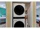 Convenient laundry area with a stacked washer and dryer unit next to bedrooms at 3312 Hawk Ridge Rd, Chapel Hill, NC 27516