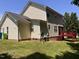 Expansive backyard featuring lush green grass, home exterior, and access to the red deck at 3609 Cold Harbour Dr, Raleigh, NC 27610