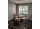 Cozy dining area with a glass-top table, ornate chairs, and natural light from large windows at 3609 Cold Harbour Dr, Raleigh, NC 27610