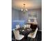 Elegant dining room with a dark wood floor, luxury table and chairs, and a stylish chandelier at 3609 Cold Harbour Dr, Raleigh, NC 27610