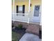 Close-up of the front porch featuring brick steps and a white railing, offering a cozy entrance at 3609 Cold Harbour Dr, Raleigh, NC 27610