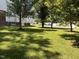 Grassy front yard shaded by mature trees, offering a view of neighboring homes in the area at 3609 Cold Harbour Dr, Raleigh, NC 27610