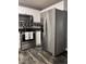 Modern kitchen featuring stainless steel appliances, white cabinets, and stylish backsplash at 3609 Cold Harbour Dr, Raleigh, NC 27610