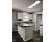 Eat-in kitchen offers great counter space and white cabinets with stainless steel sink and faucet at 3609 Cold Harbour Dr, Raleigh, NC 27610