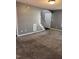 Spacious living room with neutral carpeting, gray walls, and stairs to the upper level at 3609 Cold Harbour Dr, Raleigh, NC 27610