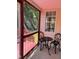 Charming porch featuring red trim and a cozy seating area with wrought iron furniture at 3609 Cold Harbour Dr, Raleigh, NC 27610