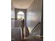 View of a carpeted staircase with a wooden banister and a window landing at 3609 Cold Harbour Dr, Raleigh, NC 27610