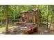 Beautiful wood home with a hot tub and deck surrounded by lush greenery at 3622 Moonlight Dr, Chapel Hill, NC 27516