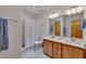 Bright bathroom featuring a double vanity, ample lighting, and a shower with a white curtain at 3622 Moonlight Dr, Chapel Hill, NC 27516