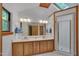 Bright bathroom with a skylight, double vanity, and a glass-enclosed shower, offering a spa-like experience at 3622 Moonlight Dr, Chapel Hill, NC 27516