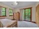 Serene bedroom with a wood bed frame, matching dresser, and a balcony overlooking a lush green forest at 3622 Moonlight Dr, Chapel Hill, NC 27516