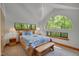 Bright bedroom with a large arch window providing serene nature views at 3622 Moonlight Dr, Chapel Hill, NC 27516