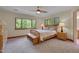 Comfortable bedroom with a large window offering scenic forest views, a ceiling fan, and neutral tones at 3622 Moonlight Dr, Chapel Hill, NC 27516