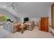 Bonus room featuring plush sofas, soft carpet, and natural light from an arched window at 3622 Moonlight Dr, Chapel Hill, NC 27516