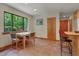 Cozy dining area with wood table set near window adjacent to the kitchen at 3622 Moonlight Dr, Chapel Hill, NC 27516