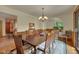 Formal dining room featuring a large table, modern chandelier, and a view into the living room at 3622 Moonlight Dr, Chapel Hill, NC 27516