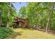 Charming two-story home with a wooden exterior nestled among mature trees and natural landscaping at 3622 Moonlight Dr, Chapel Hill, NC 27516