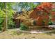 Charming multi-story home with natural wood siding, landscaped yard, and mature trees at 3622 Moonlight Dr, Chapel Hill, NC 27516