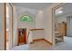 Upstairs hallway with a dormer window providing an expansive view of the surrounding lush greenery at 3622 Moonlight Dr, Chapel Hill, NC 27516