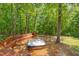 Hot tub on a wooden deck surrounded by a lush forest landscape at 3622 Moonlight Dr, Chapel Hill, NC 27516