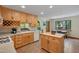 Well-lit eat-in kitchen featuring tile floors, wood cabinets, white appliances, and butcher block island at 3622 Moonlight Dr, Chapel Hill, NC 27516