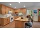 Well-lit eat-in kitchen featuring tile floors, wood cabinets, white appliances, and butcher block island at 3622 Moonlight Dr, Chapel Hill, NC 27516