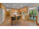 Bright eat-in kitchen featuring tile floors, wood cabinets, white appliances, and a butcher block island at 3622 Moonlight Dr, Chapel Hill, NC 27516