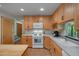 Bright kitchen featuring tile floors, wood cabinets, white appliances, and a butcher block island at 3622 Moonlight Dr, Chapel Hill, NC 27516